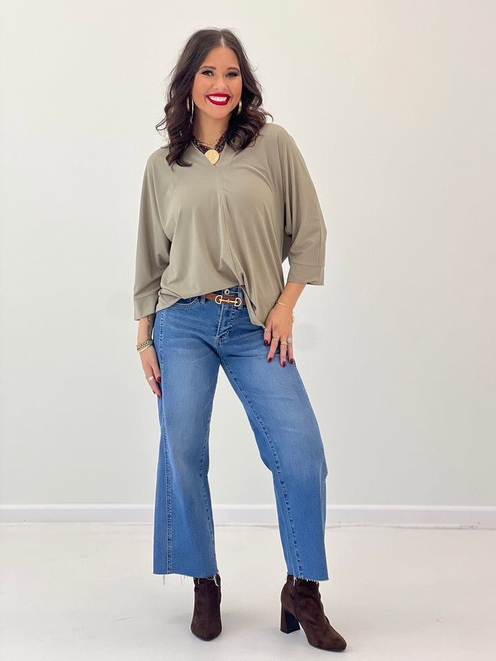 V-neck quarter-sleeve top in khaki with a relaxed fit and curved hem
