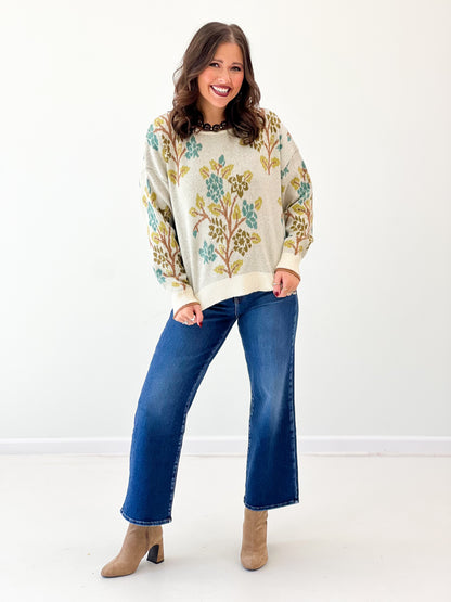 Cream tree-printed sweater top with crew neck, long sleeves, ribbed cuffs and hem