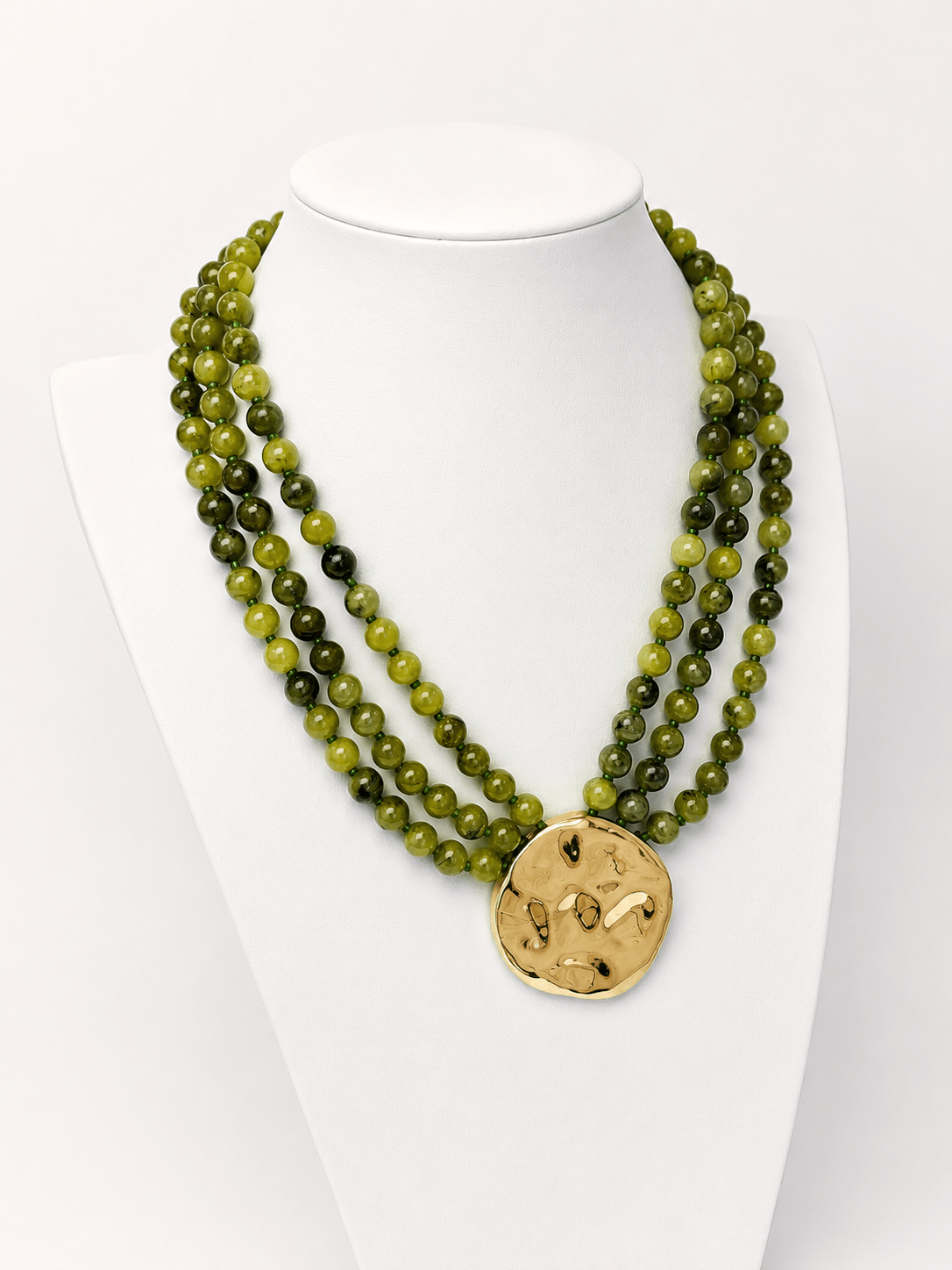 Layered necklace mixing beads and a pendant charm