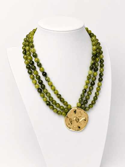 Layered necklace mixing beads and a pendant charm