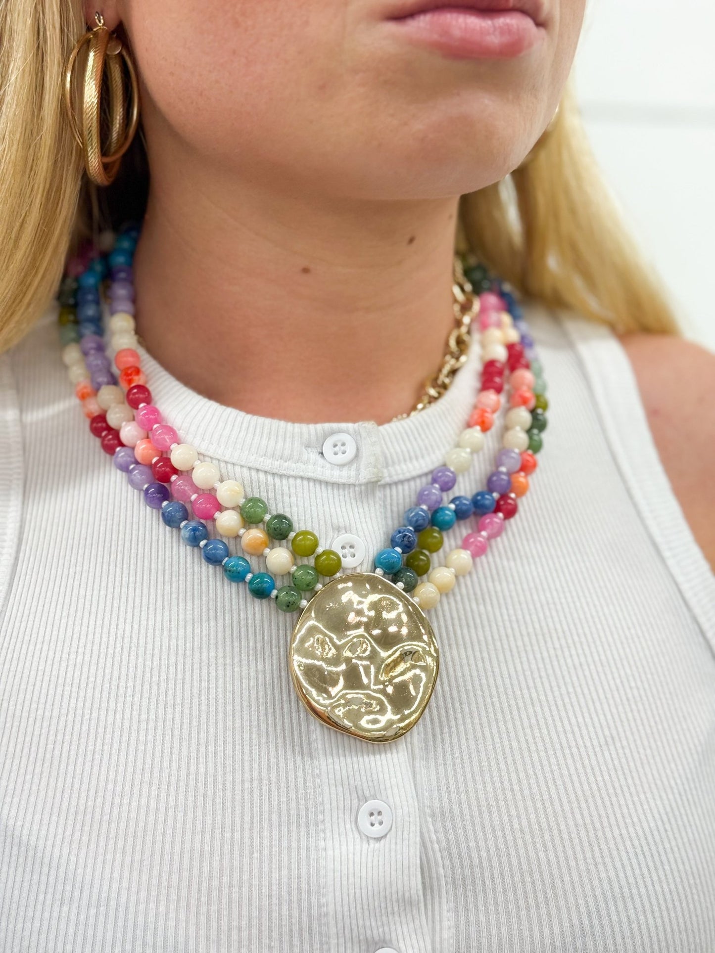 Multi-layer bead necklace with a gold-tone pendant