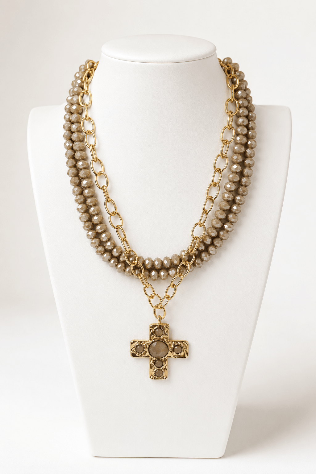 Layered cross pendant necklaces in neutral beige and gold tones