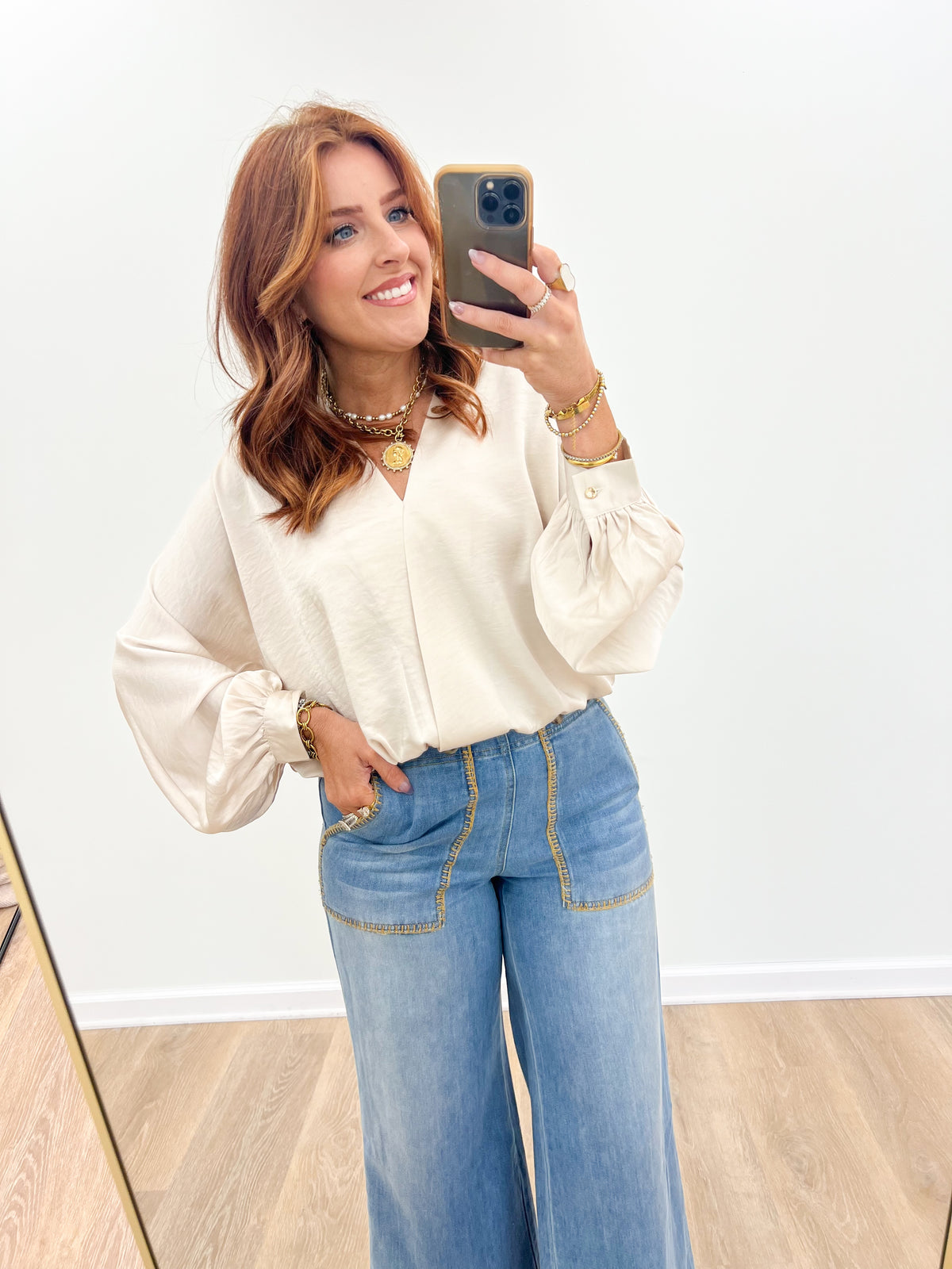 Cream wrap V-neck long-sleeve blouse, draped neckline and gathered cuffs