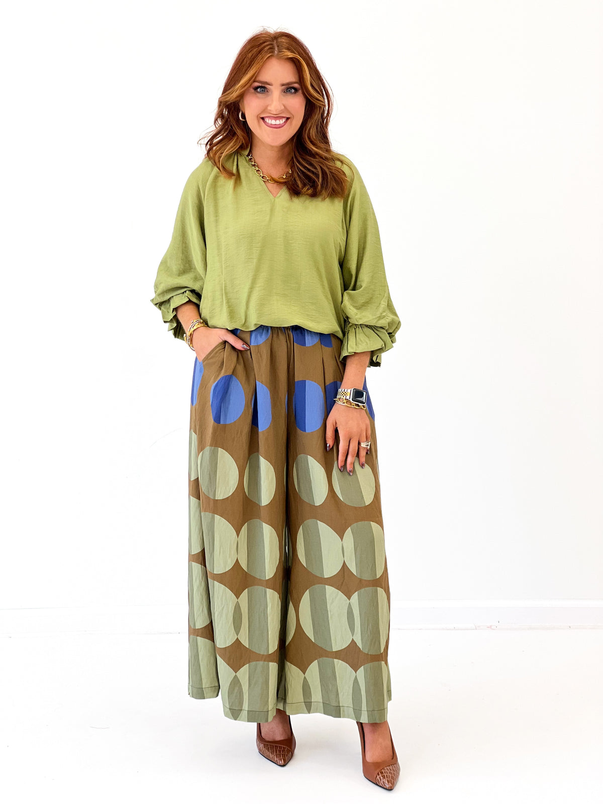 Wide-leg midi printed pants in olive mix with tan, blue, and green circle designs