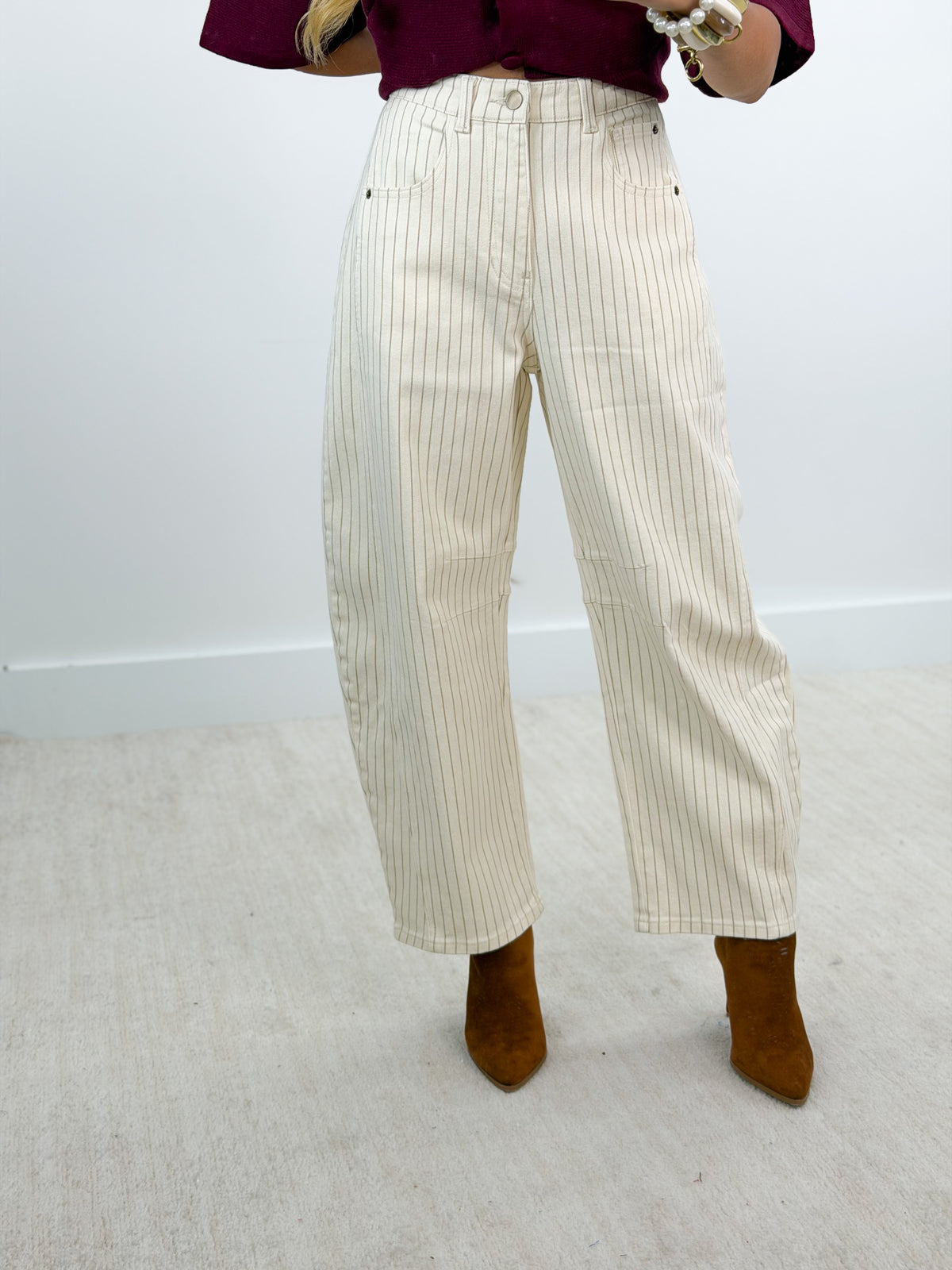 Cream pinstripe barrel pants with vertical pinstripes and relaxed barrel leg