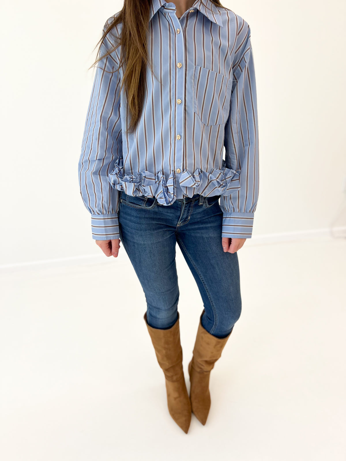Women's blue striped button-front top with ruffled hem and button placket