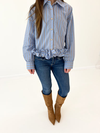 Women's blue striped button-front top with ruffled hem and button placket