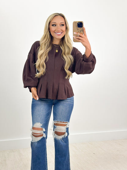 Plum long-sleeve peplum top with gathered waist and elastic cuffs