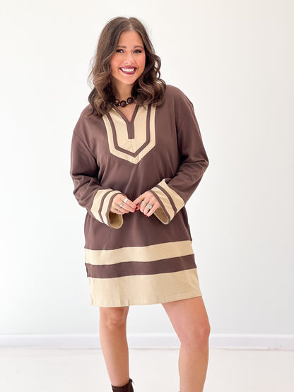 Brown V-neck color-block sweatshirt dress with cream yoke, cuffs, and hem stripe