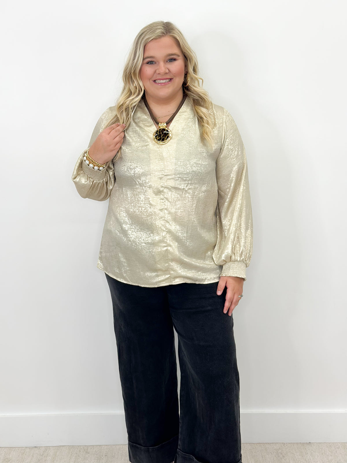 Shimmer gold V-neck top with long sleeves and shirred cuffs