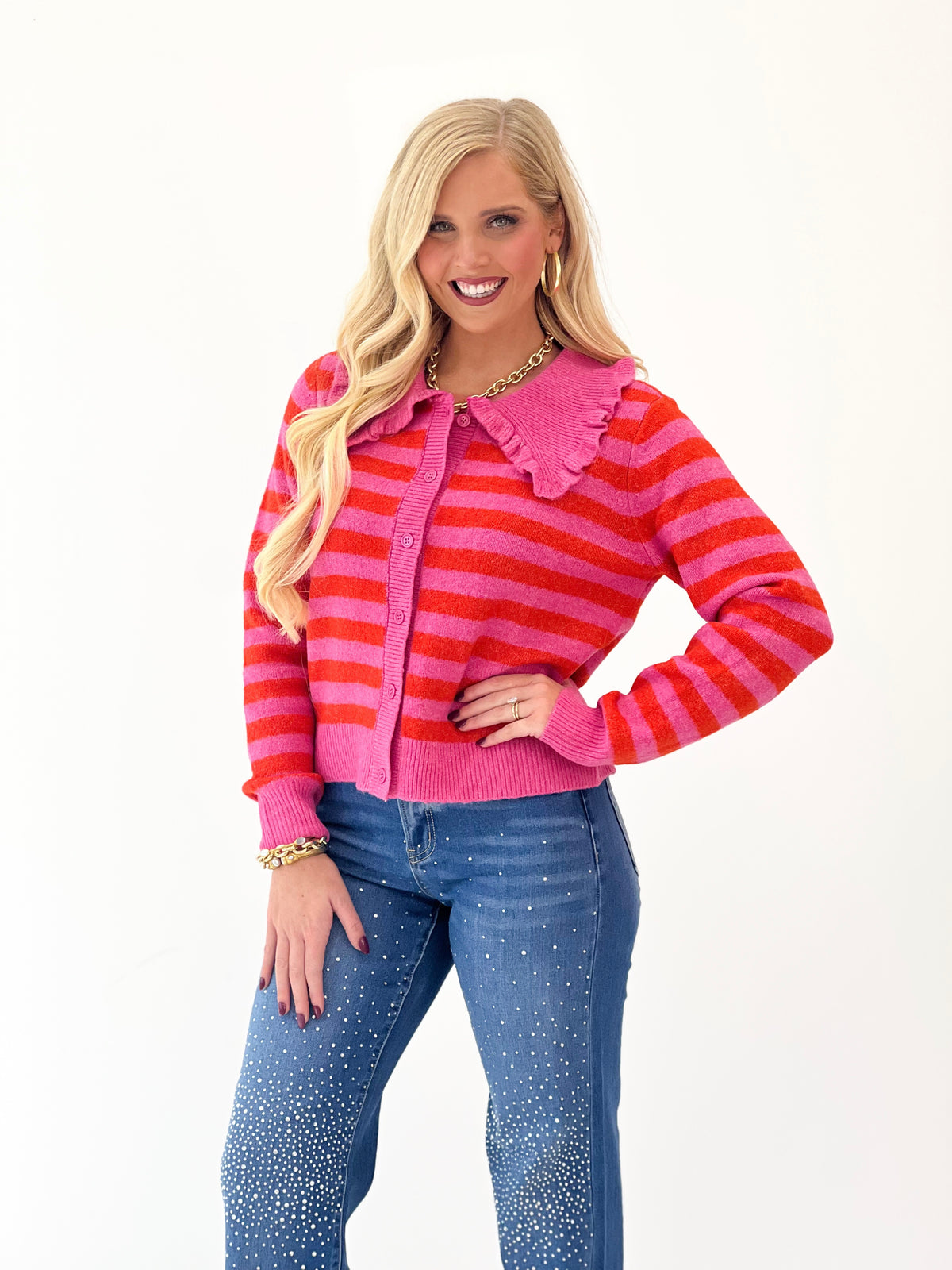 Hot pink striped sweater cardigan with ruffled shoulder collar, button-front and long sleeves