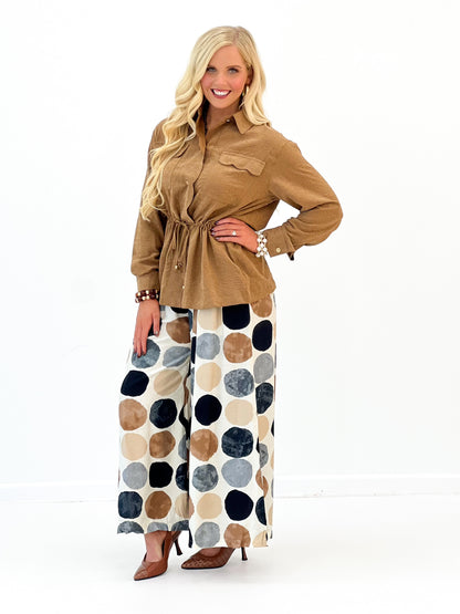 Wide-leg dot print pants, full length; cream background with large navy and brown circles