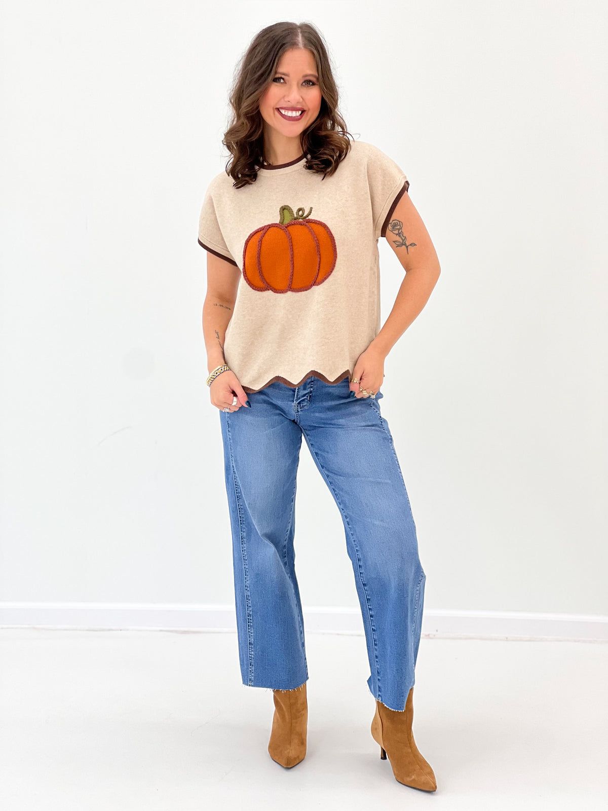 Light taupe scallop-hem sweater top with short sleeves and pumpkin graphic