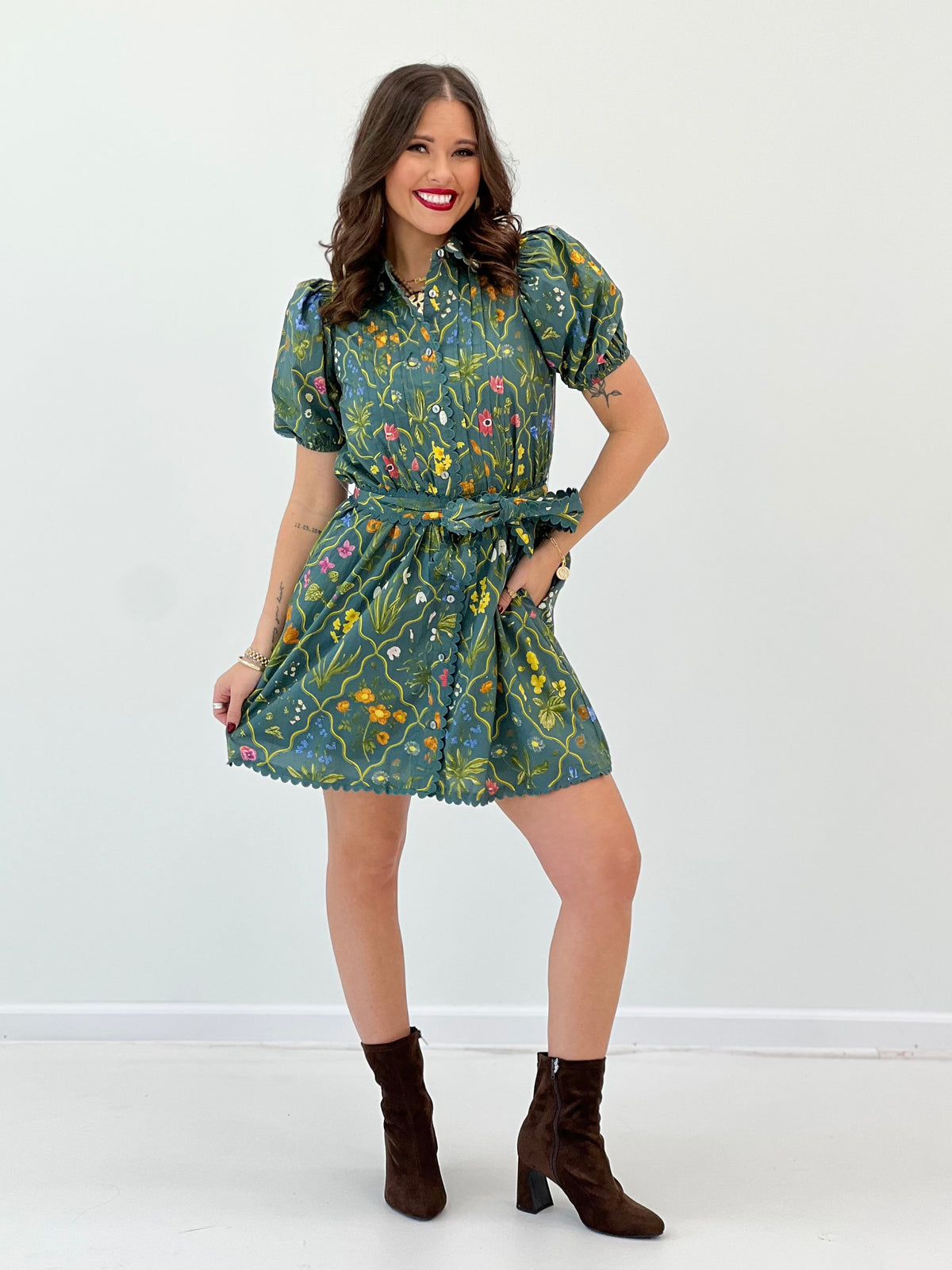 Teal floral mini dress with puff sleeves, gathered tie waist and scalloped hem