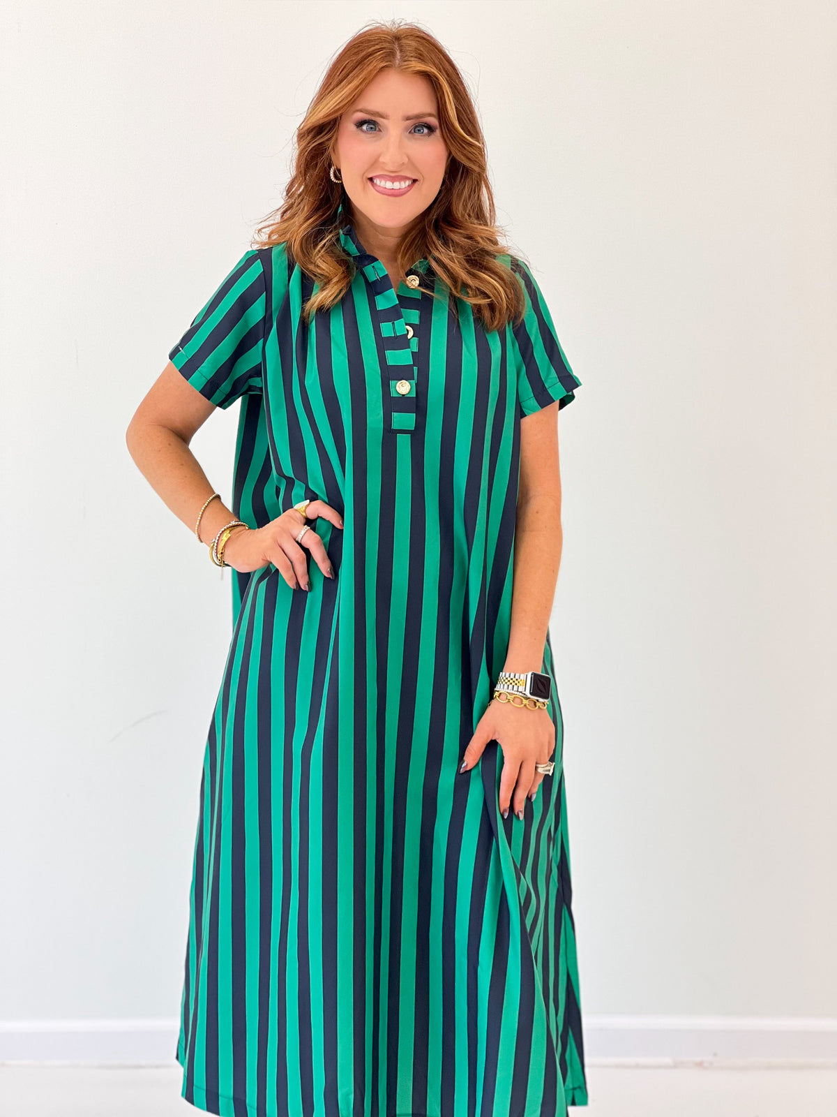 Teal striped midi dress with high neck, button placket, and short sleeves; front close