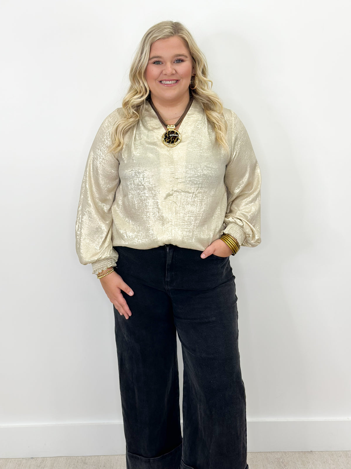 Shimmer gold V-neck top with ruched sleeve cuffs
