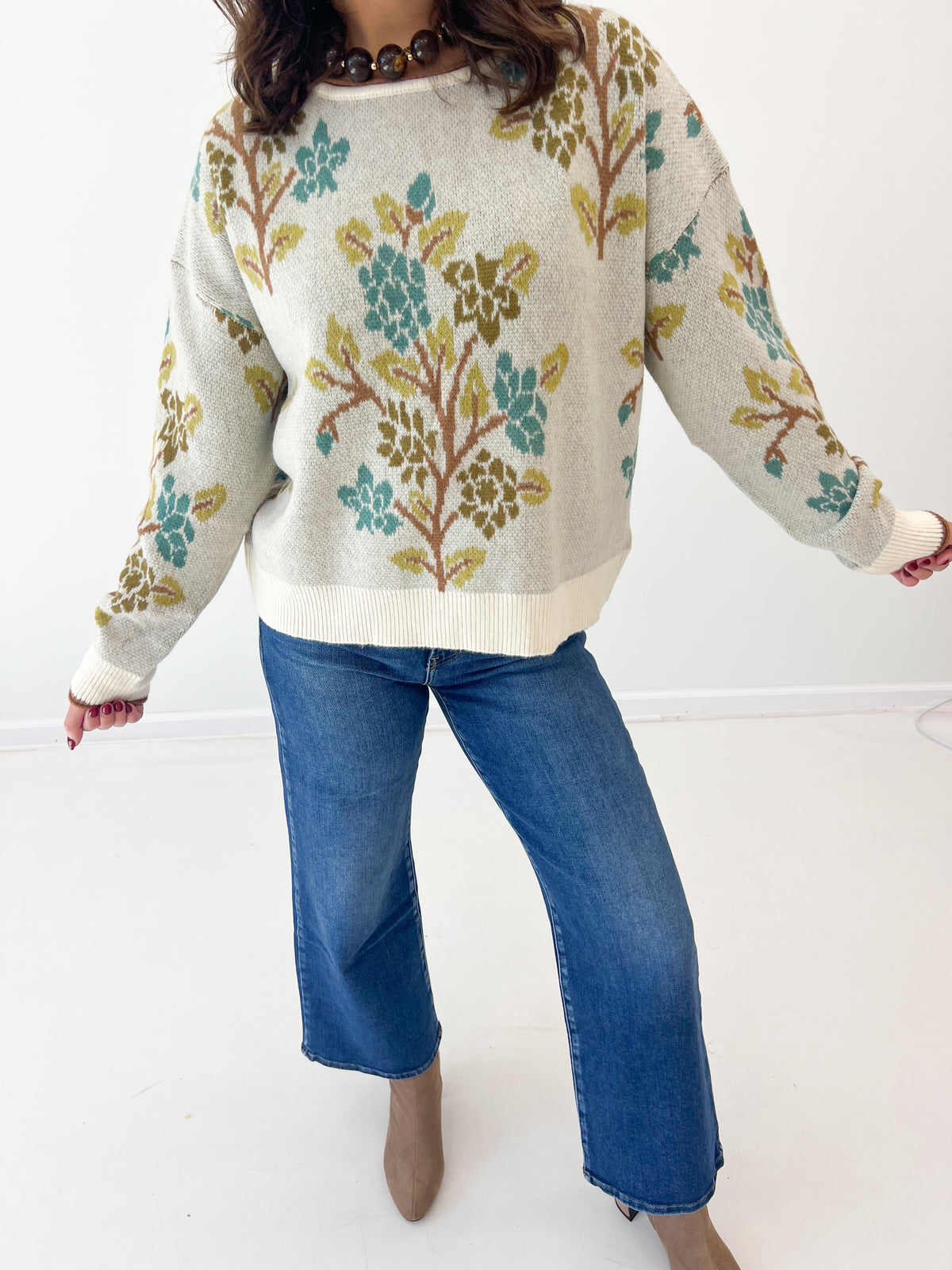 Cream tree-printed sweater top with long sleeves and ribbed hem, crew neckline