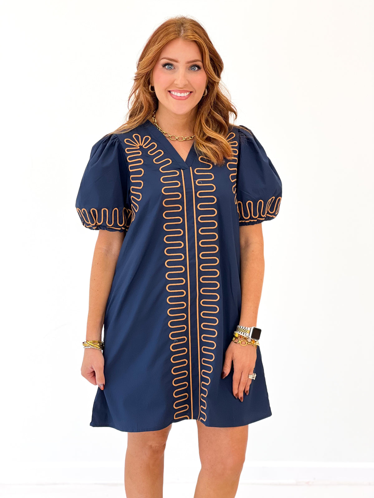 Navy short-sleeve dress with red embroidered center placket and outlined shoulder motifs