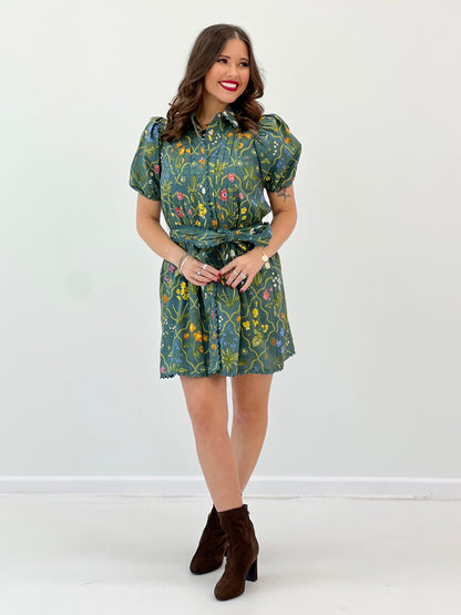 Teal floral mini dress with short puff sleeves, front tie waist and scalloped edges