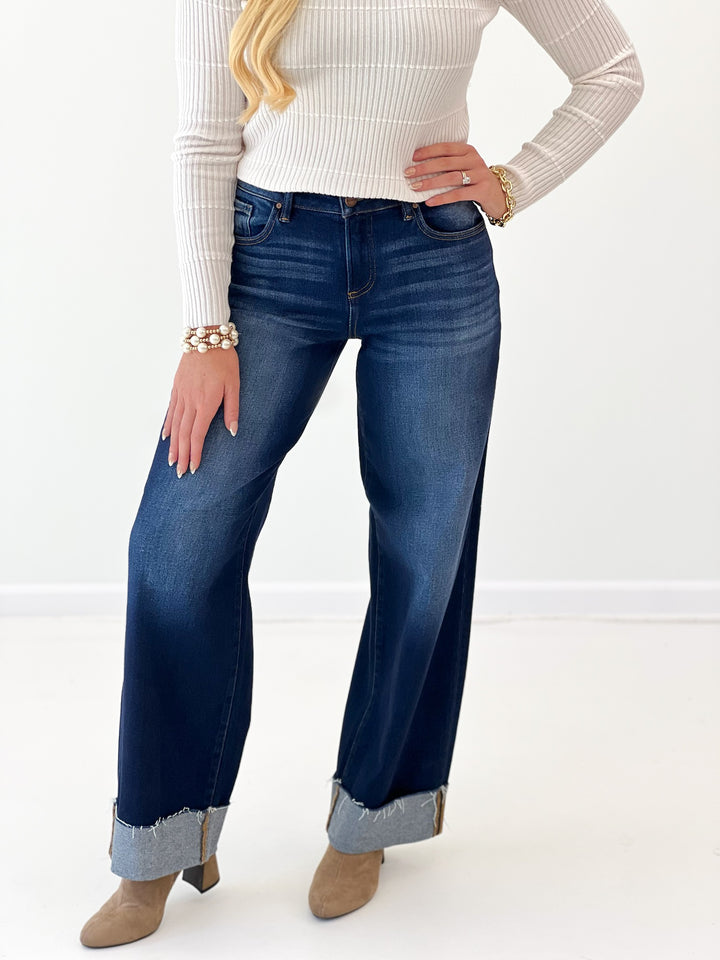 Deep blue barrel jeans with cuffed hems, zip fly, and five-pocket styling