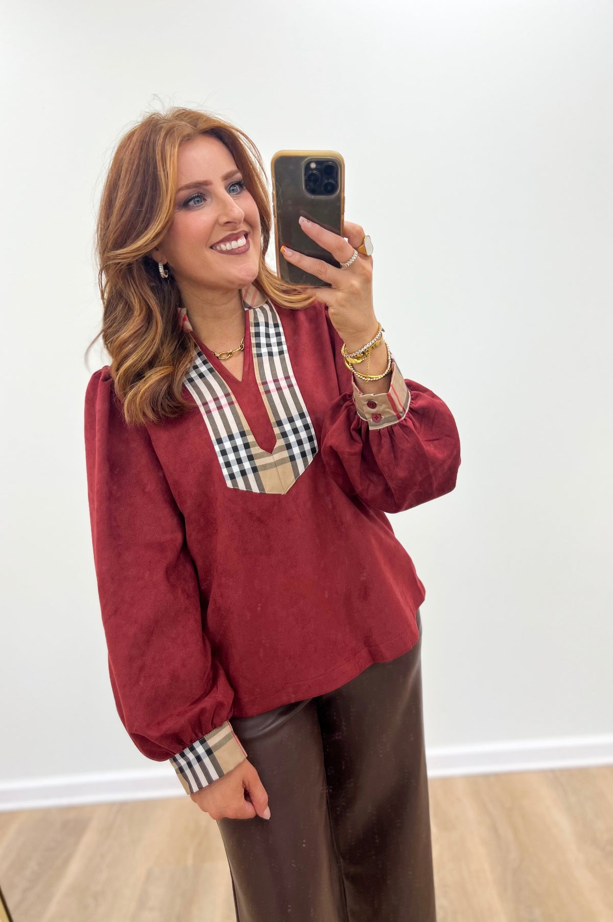 Burgundy faux suede puff-sleeve top with plaid trim V neckline