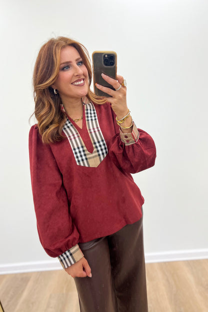 Burgundy faux suede puff-sleeve top with plaid trim V neckline