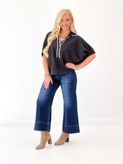Black V-neck scrunch sleeve top with contrast front trim, relaxed silhouette