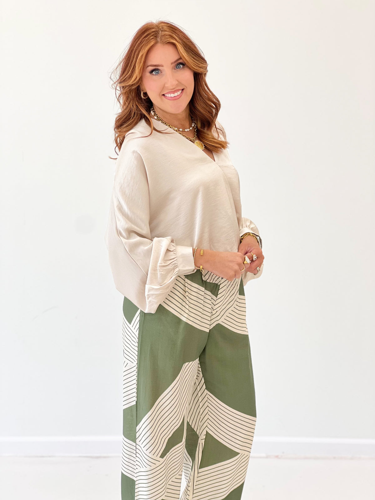 Cream wrap V-neck long-sleeve blouse with ruched sleeves and tie-front detail
