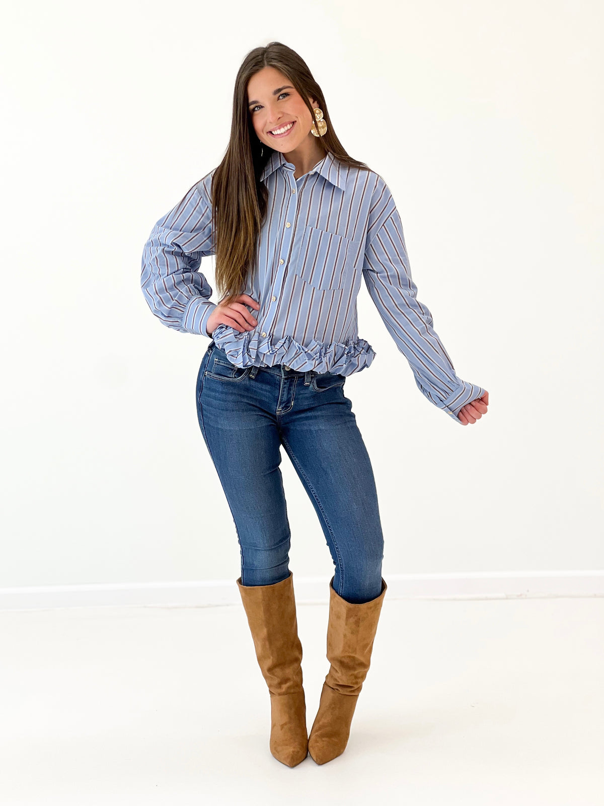 Women's blue striped long-sleeve button-front top with ruffled lower edge