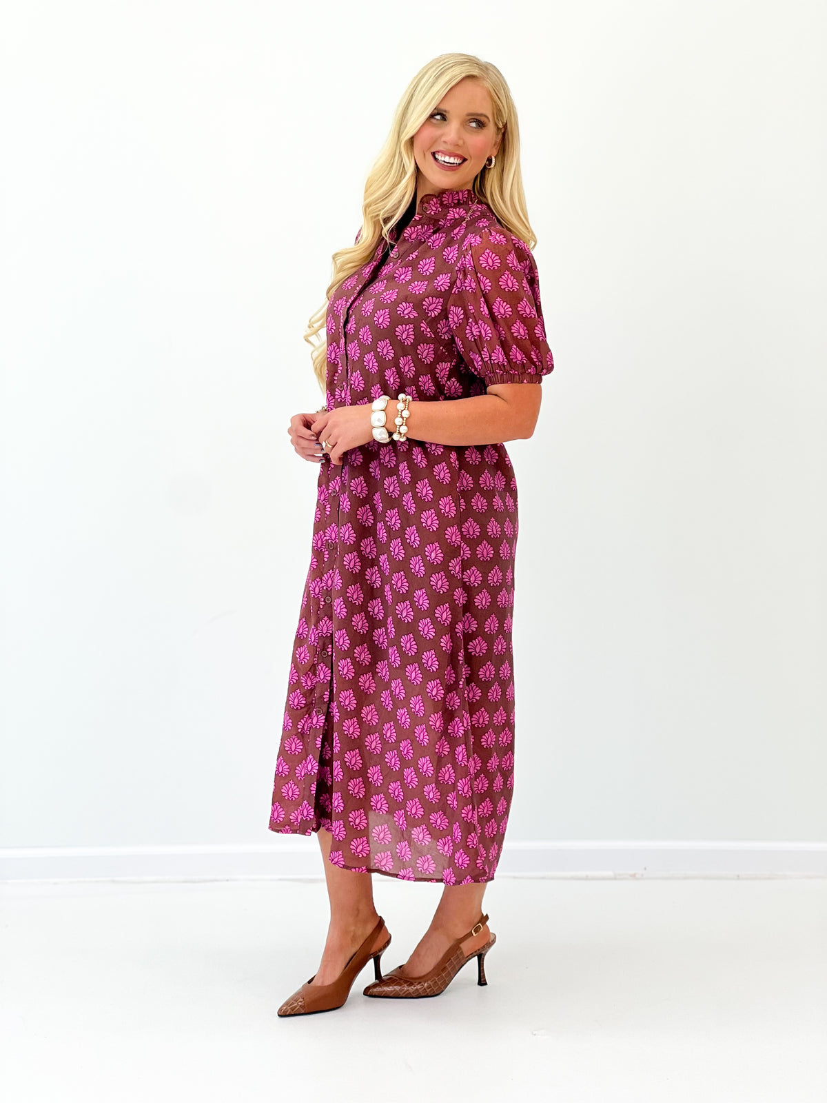Magenta printed midi button-down dress, three-quarter profile with ruffled collar