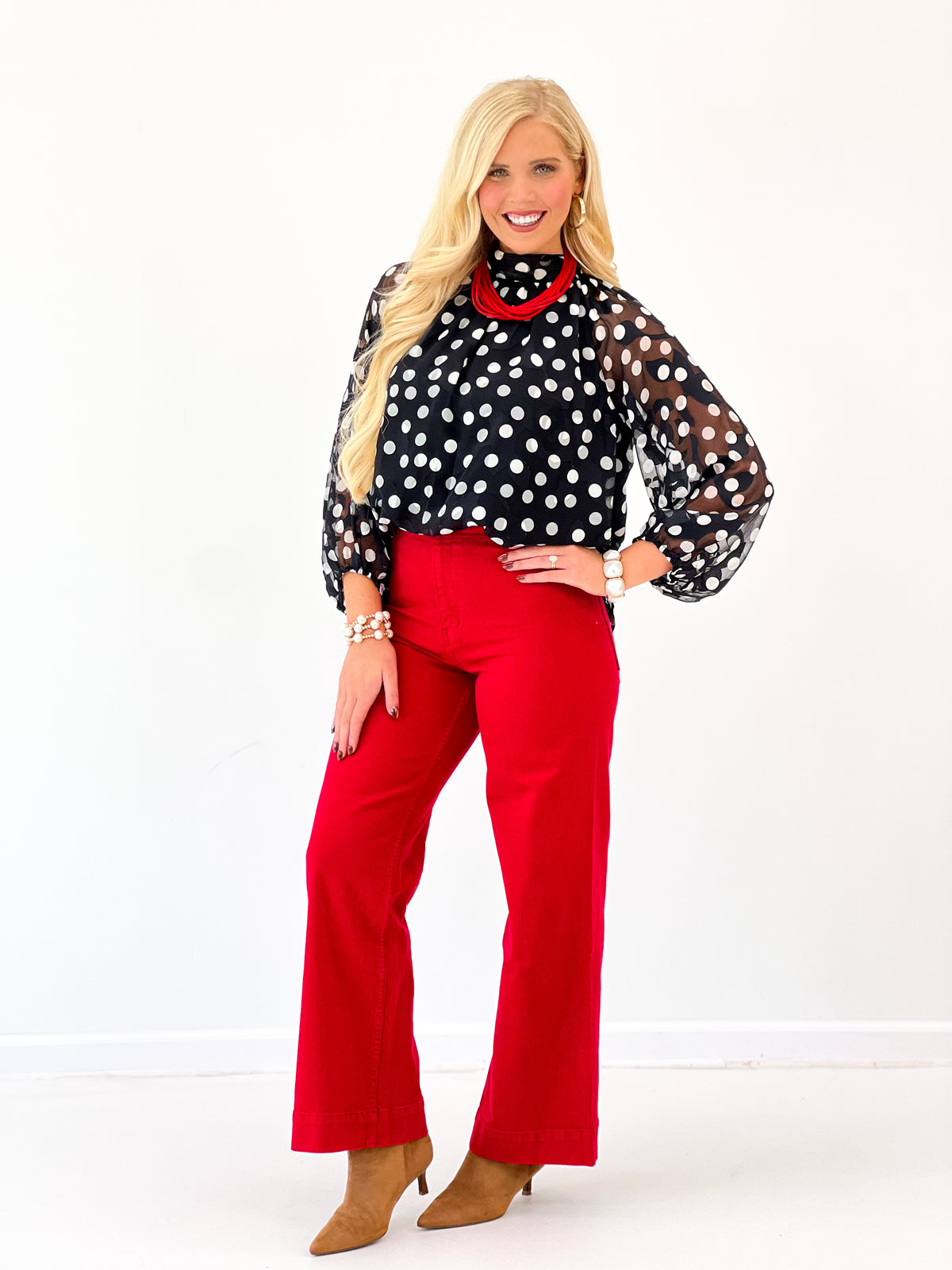 Black polka dot high-neck long-sleeve blouse with red contrast collar