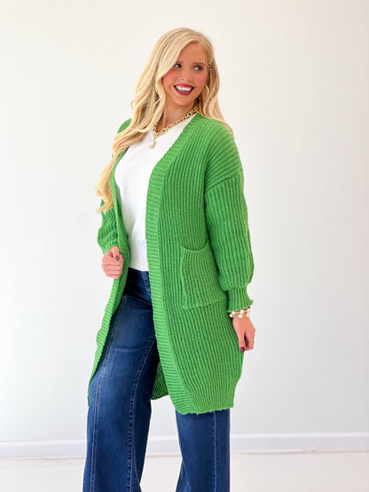 Green oversized loose-knit duster cardigan with chunky texture and open front