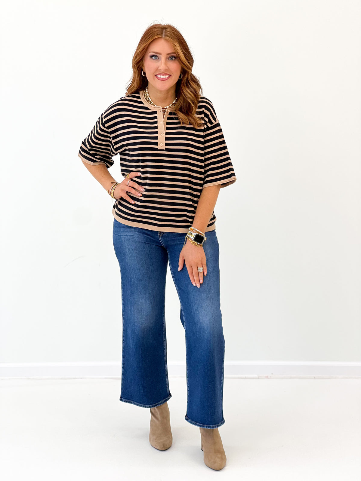 Striped short-sleeve sweater top with quarter-button placket and ribbed trim, black stripes