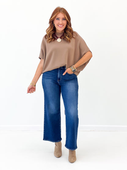 Taupe short sleeve scuba dolman top featuring wide sleeves and round neckline
