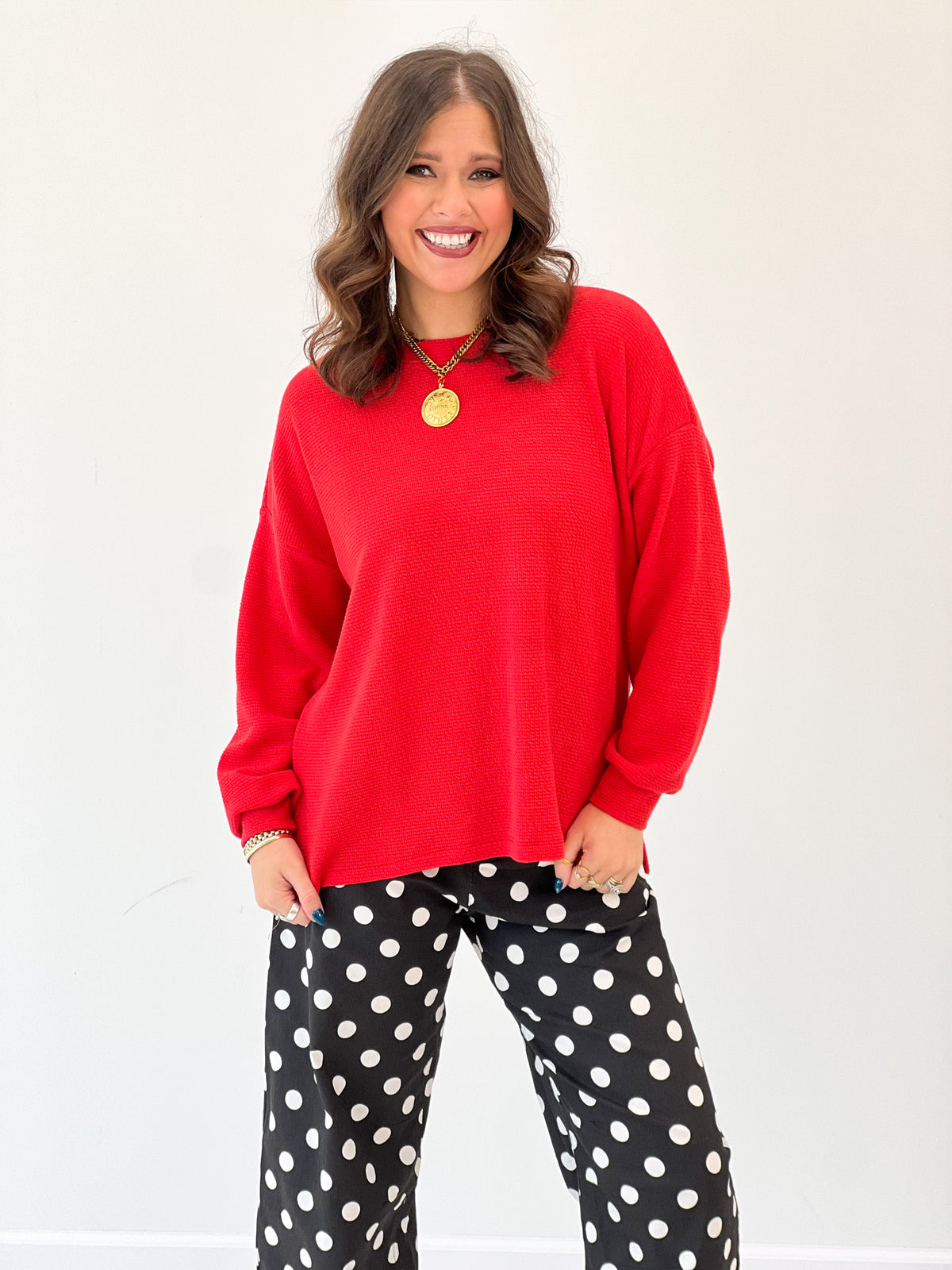 Red crew-neck long-sleeve knit top with loose drape