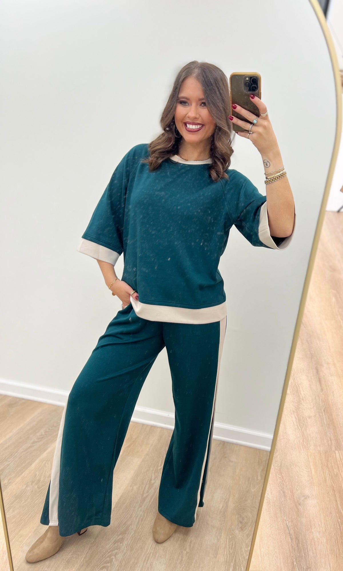 Women’s teal crewneck knit set with cream-trim cuffs and wide-leg trousers