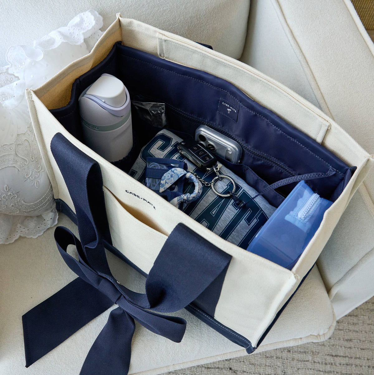 Navy tote organizer with tied side handles and interior pocket compartments