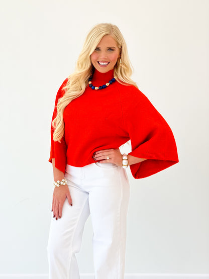 Red mock neck sweater with wide batwing sleeves and relaxed fit
