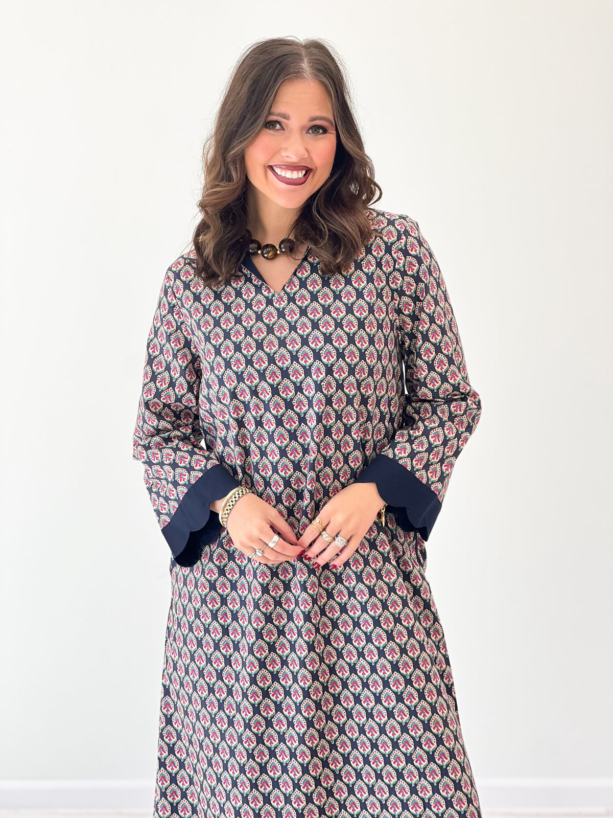Navy floral V-neck maxi dress close-up, long sleeves with scalloped neckline and hem