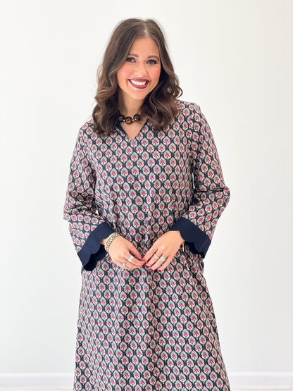 Navy floral V-neck maxi dress close-up, long sleeves with scalloped neckline and hem