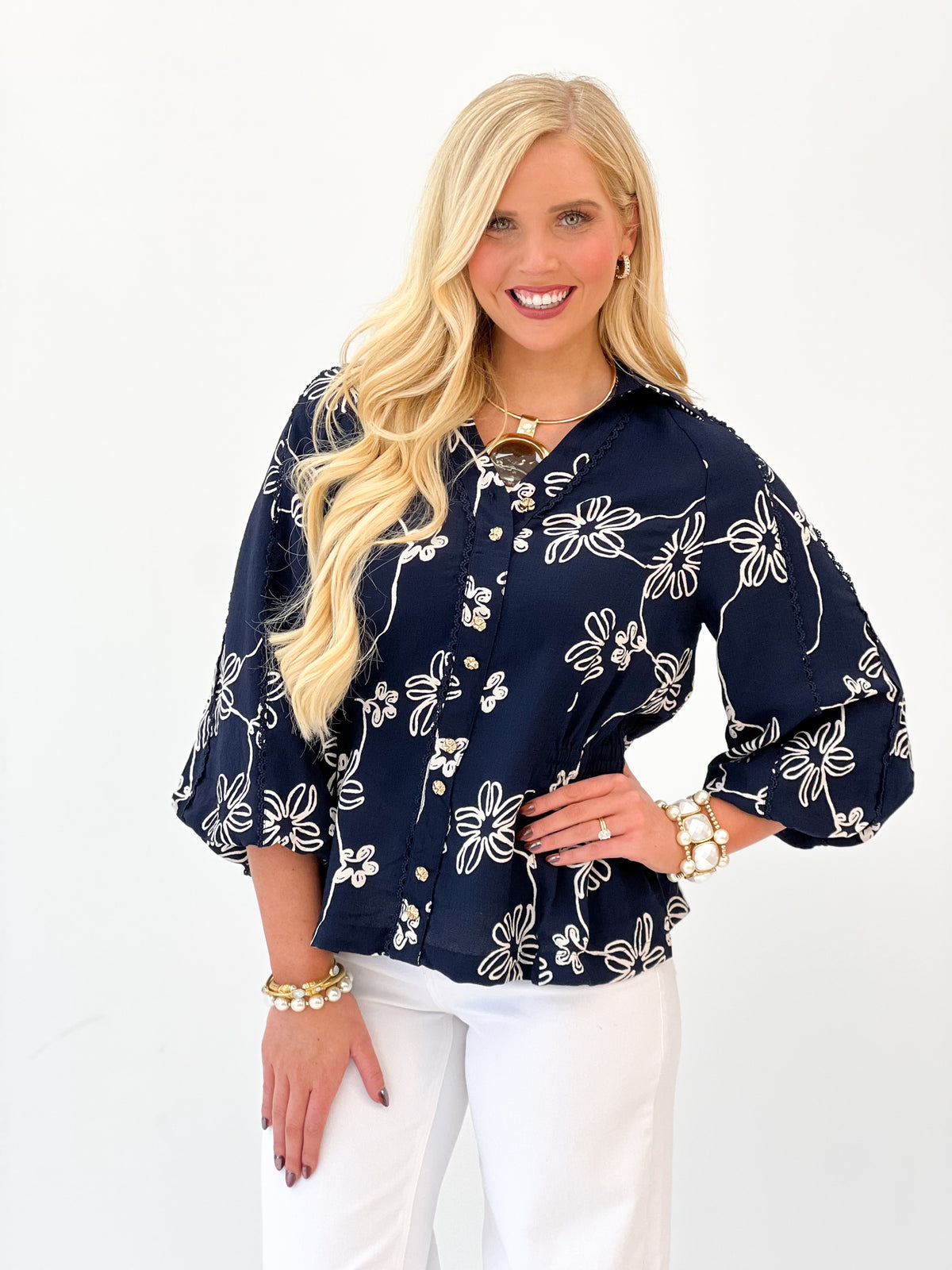Navy floral button-front top with embroidered-style flower pattern