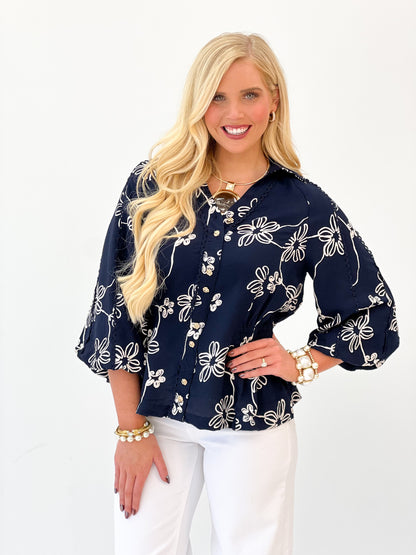 Navy floral button-front top with embroidered-style flower pattern