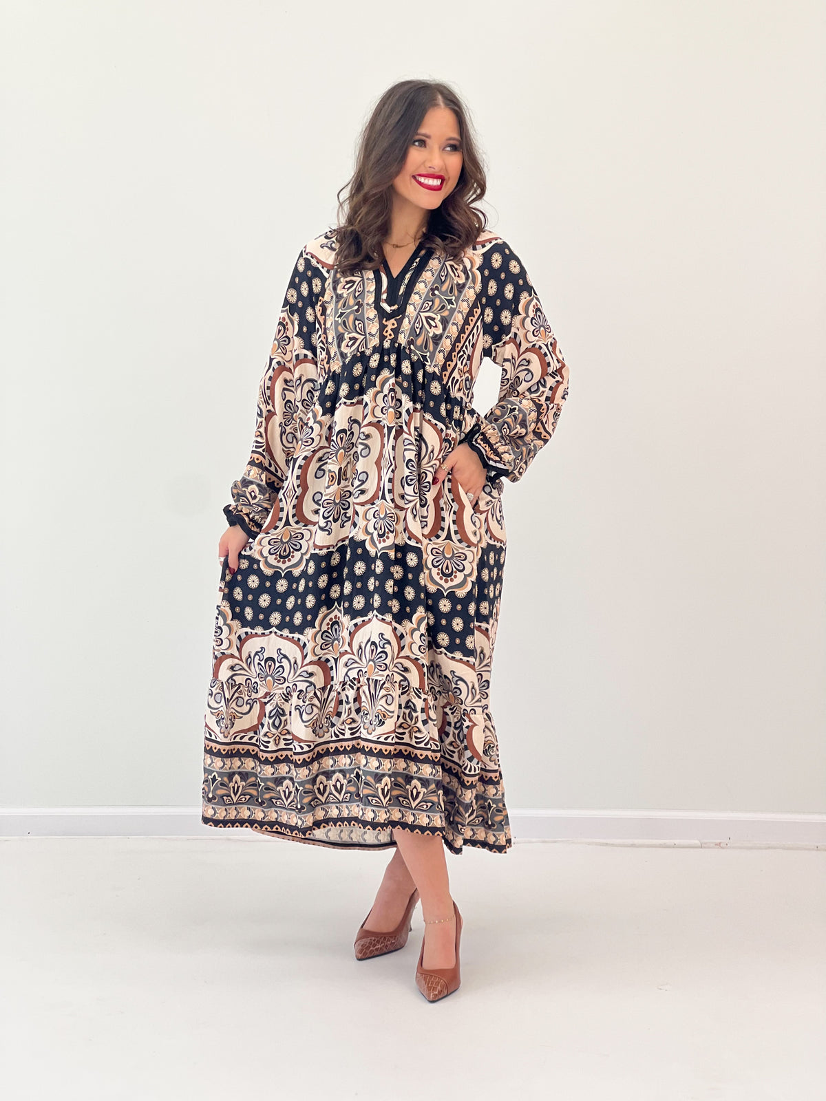Abstract print midi dress with contrast trim, V-neck, and long sleeves