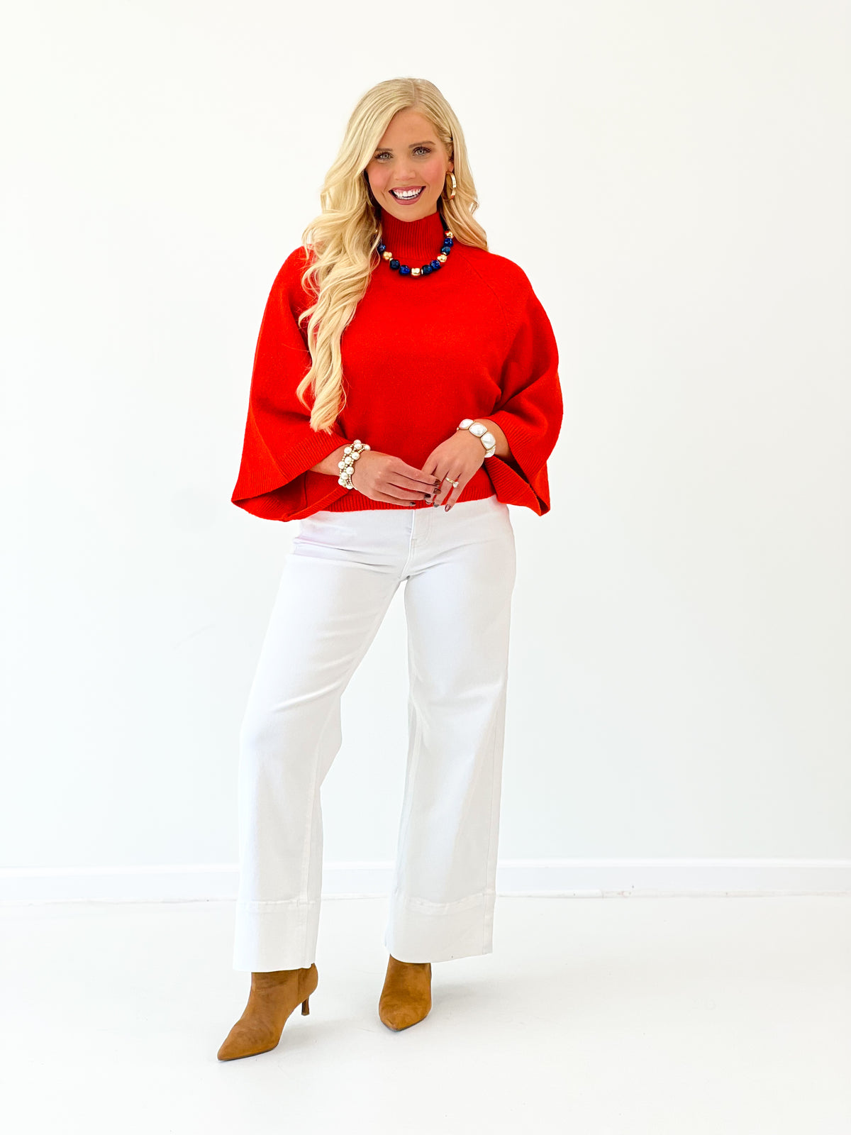 Red mock neck sweater with wide sleeves and loose drape