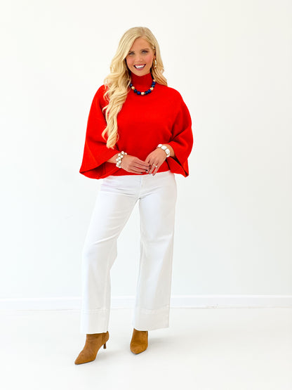 Red mock neck sweater with wide sleeves and loose drape