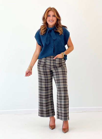 Teal knit sweater vest with button front and bow tie neckline, short sleeves