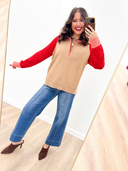 Taupe-and-red color-block sweater with half-zip neckline and long sleeves
