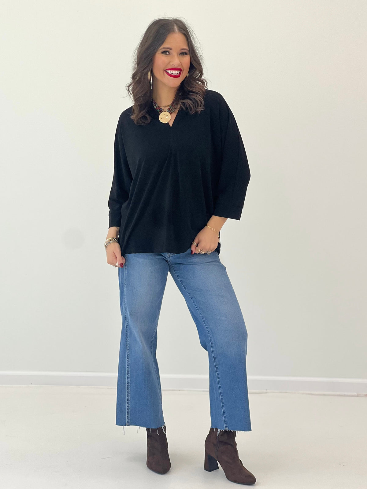 V-neck quarter-sleeve top in black with roomy cut and soft drape