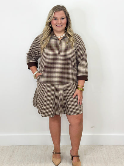 Brown gingham half-zip mini dress with long sleeves and flared skirt