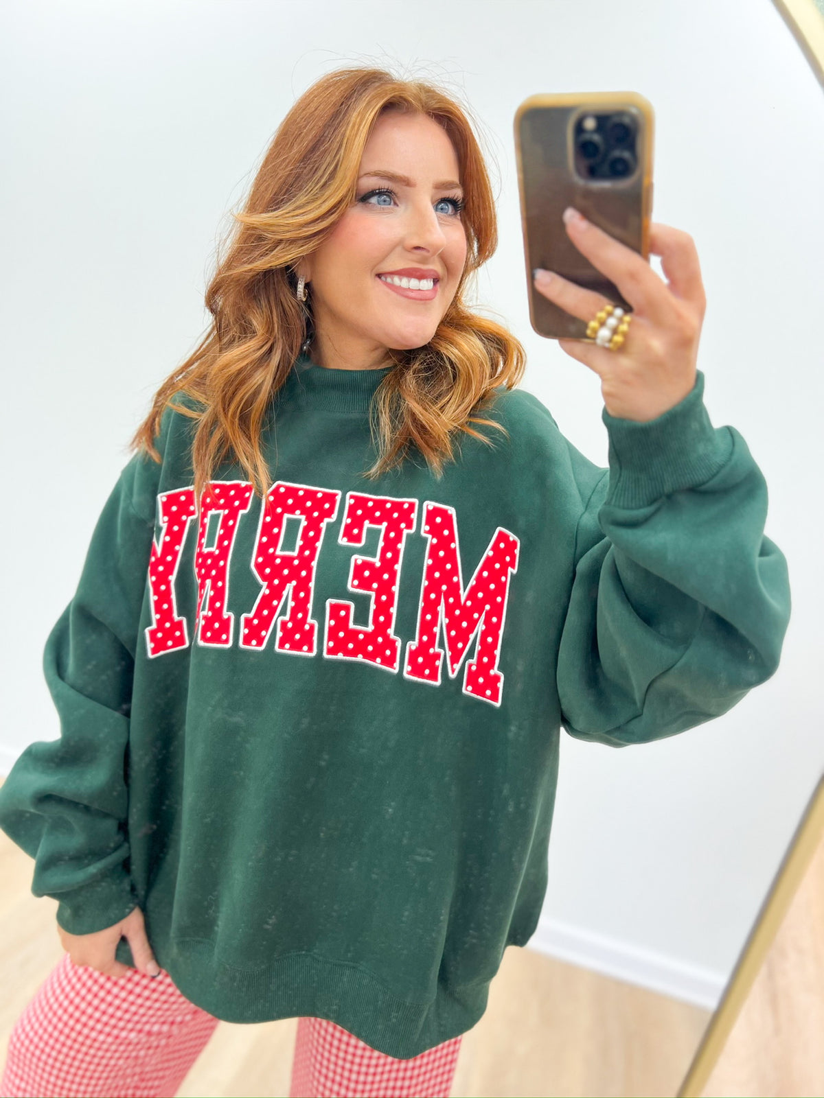 Hunter green mock-neck sweatshirt with red-and-white 'MERRY' graphic on front